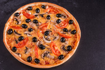 Tasty fresh hot pizza against a dark background. Pizza, food, vegetable, mushrooms