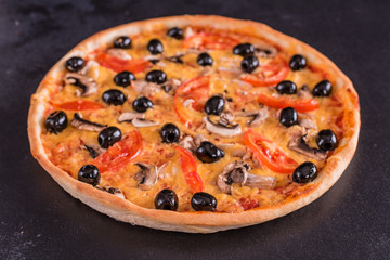Tasty fresh hot pizza against a dark background. Pizza, food, vegetable, mushrooms