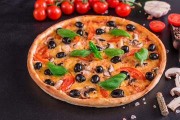 Tasty fresh hot pizza against a dark background. Pizza, food, vegetable, mushrooms