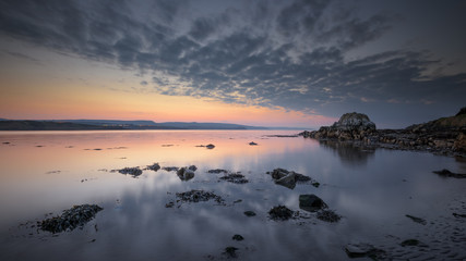 Dusk at low tide on Browns Bay, Islandmagee, County Antrim, Northern Ireland.