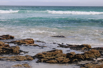 Blue Ocean waves over rocks