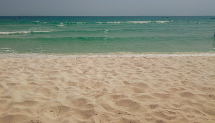 Palm trees, white sandy beach and turquoise water in Tulum beach, Mexico