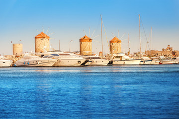 Naklejka premium Tourist and history landmarks - Windmills in the Mandraki sea port of Rhodes, Greece