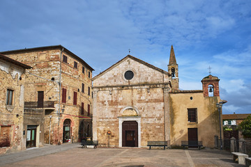 Fototapeta na wymiar Stone, medieval church with a bell tower in the village of Magliano in Toscana, Italy.
