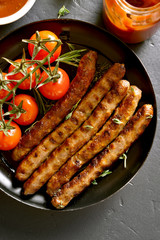 Fried sausage and cherry tomatoes