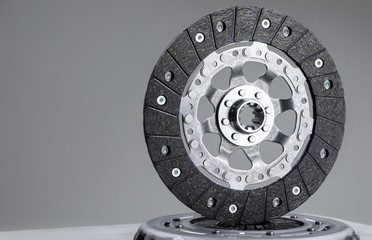 Car clutch plate on a gray background, new part, car warranty service