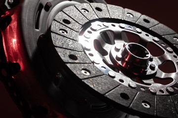 car part close-up on a dark background, clutch disc and basket, release bearing