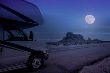 recreational vehicle in monument valley at full moon night