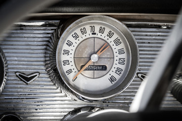 Vintage car dashboard close up with speedometer