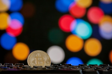 Bitcoin currency on keyboard computer on bokee background.Virtual cryptocurrency concept.