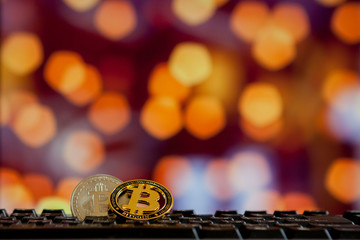 Bitcoin currency on keyboard computer on bokee background.Virtual cryptocurrency concept.