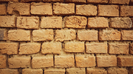 Old brick wall texture with light in the middle and shadow on the edges