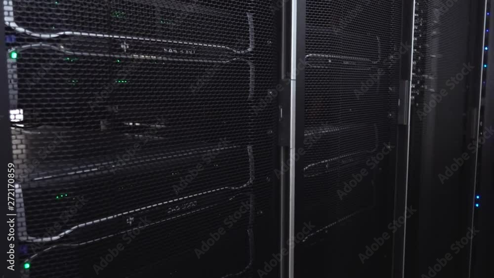 Poster dark modern working data servers with flashing led green lights.