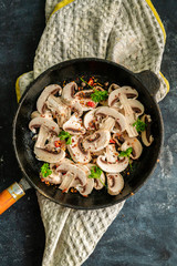 oiled hot saucepan filled with chopped champignons, mushroom cookings