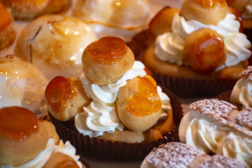 Freshly baked stuffed sweet Saint-Honore pastries in traditinal French bakery in small village in Provence