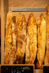 Freshly baked traditional baguettes and bread in small rustic bakery in Provence, South of France