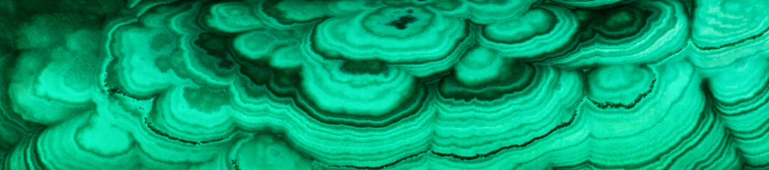 Fototapeta na wymiar The green malachite. An ornamental stone. Photo texture. Macro.