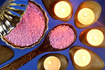 Sea salt treatment, candles on the stones Spa treatments, a healthy lifestyle. Sea salt for baths, nourishes the skin with natural minerals and vitamins, restores and heals.