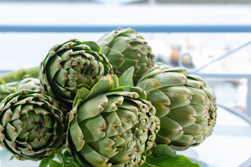 Obraz premium Bunch of fresh raw artichokes heads from artichoke plantation in Argolida, Greece ready to cook