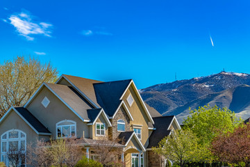 House exterior against mountain and blue sky viewed on a sunny day