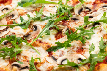 Italian Delicious Fresh Hot Mix Baked Pizza with Melting Cheese, sliced mushrooms , tomato sauce and cheddar serving on textured rustic background. Mushrooms pizza. top view.