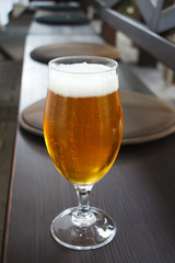 Closeup of a glass of light beer on the bar, summer vacation concept, selective focus