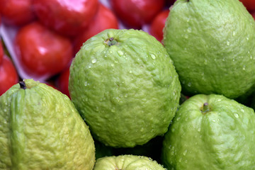 Closeup of guava heap, with water droplets
