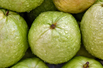 Closeup of guava heap, with water droplets