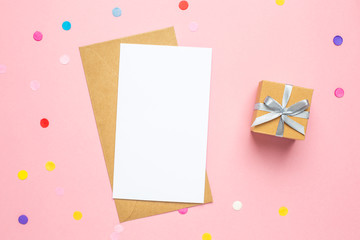 Greeting card and color confetti on pink table with space for text. Composition for birthday,...