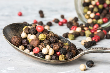 Four Colored Peppercorns on a Vintage Spoon