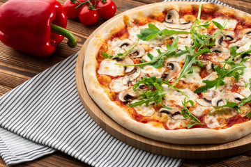 Italian Delicious Fresh Hot Mix Baked Pizza with Melting Cheese, sliced mushrooms , tomato sauce and cheddar serving on textured rustic background. Mushrooms pizza. top view.