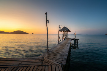 Fototapeta na wymiar Long wooden bridge in beautiful tropical island beach - Koh Mak in Trat, Thailand.