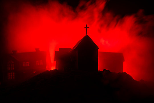 Old house with a Ghost in the forest at night or Abandoned Haunted Horror House in fog. Old mystic building in dead tree forest. Trees at night with moon. Surreal lights.