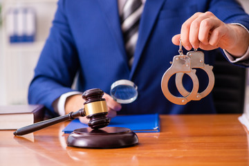 Young male judge sitting in courtroom 