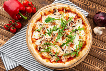 Italian Delicious Fresh Hot Mix Baked Pizza with Melting Cheese, sliced mushrooms , tomato sauce and cheddar serving on textured rustic background. Mushrooms pizza. top view.