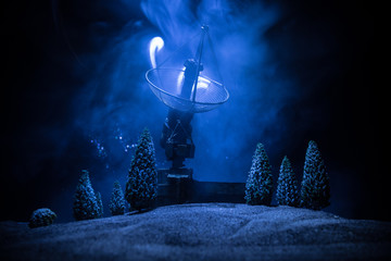 Silhouettes of satellite dishes or radio antennas against night sky. Space observatory.