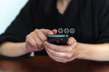 Woman using phone for service rating and costumer satisfaction