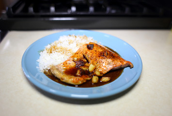 Plate of sockeye salmon with teriyaki demiglace and basmati rice.