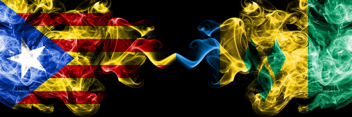 Catalonia vs Saint Vincent and the Grenadines smoke flags placed side by side. Thick colored silky smoke flags of Catalonia and Saint Vincent and the Grenadines