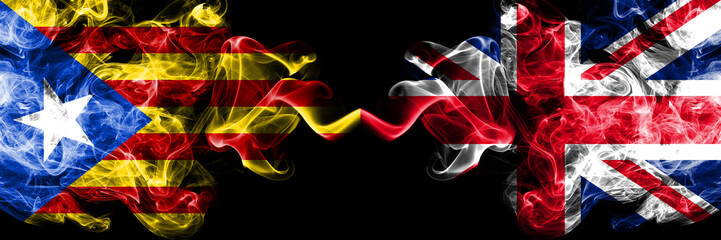 Catalonia vs United Kingdom, British smoke flags placed side by side. Thick colored silky smoke flags of Catalonia and United Kingdom, British