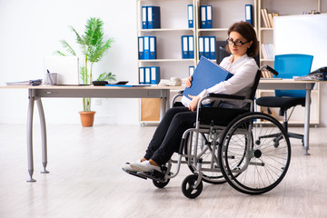 Female employee in wheel-chair at the office  