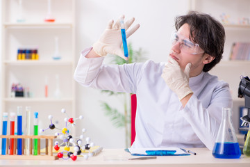 Young male biochemist working in the lab 