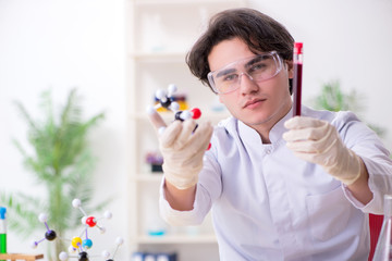 Young male biochemist working in the lab 