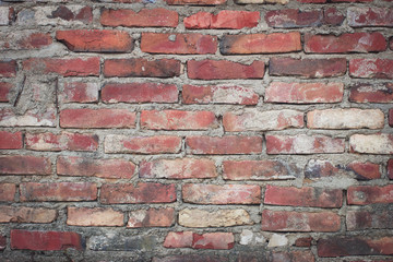 Obraz premium Old red brick wall, old texture of red stone blocks closeup. Wall texture. Background of old vintage brick wall.