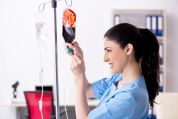 Young female doctor in infusion concept 