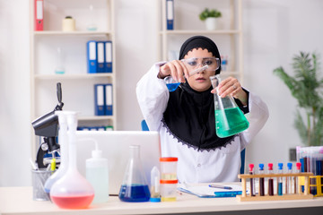Female chemist in hijab working in the lab