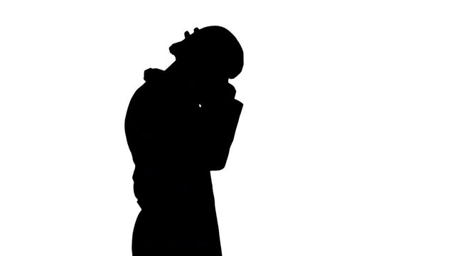 Silhouette Arabic doctor walking and putting medical cap on.