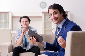 Young male patient discussing with psychologist personal problem
