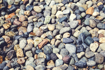 A background of pebbles and rocks near the shoreline