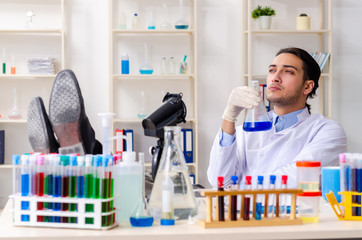 Young male chemist working in the lab 